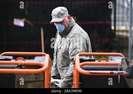 New York City, USA. 25th Mar, 2020. Members Air Force Reserve set up tents and moved medical related equipment as they build a makeshift morgue outside Bellevue Hospital to handle potential high number of Coronavirus victims, New York, NY, March 25, 2020. On Tues. March 24, New York Gov. Adrew Cuomo predicted that those infected with COVID-19 could reach over 100,000 with 40,000 needing intensive care. (Anthony Behar/Sipa USA) Credit: Sipa USA/Alamy Live News Stock Photo