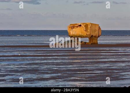 Bunker remains of an anti-aircraft gun position from World War II on the Minsener Oog power station in the evening light, Lower Saxony Wadden Sea Stock Photo