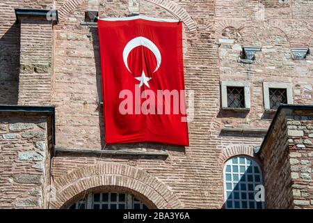 Turkish flag on the brick wall of the Hagia Sophie, Istanbul, Turkey Stock Photo
