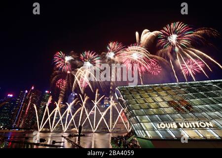 Fireworks over the Marina Bay Sands Reservoir with Louis Vuitton Shopping Mall, Singapore Stock Photo