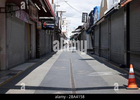 LOS ANGELES, CA/USA - MARCH 19, 2020: The usually crowded Santee Alley in the Los Angeles Fashion district boarded up and empty during the coronavirus Stock Photo