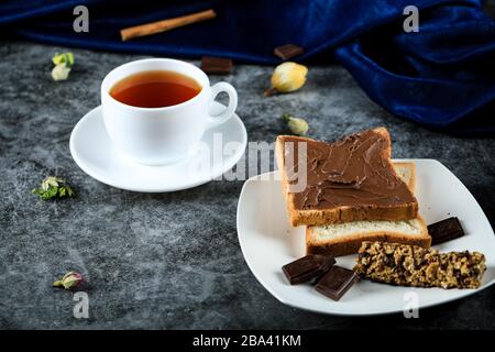 Chocolate cream toast served with a cup of tea Stock Photo