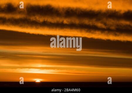Sun setting over Atlantic Ocean Stock Photo