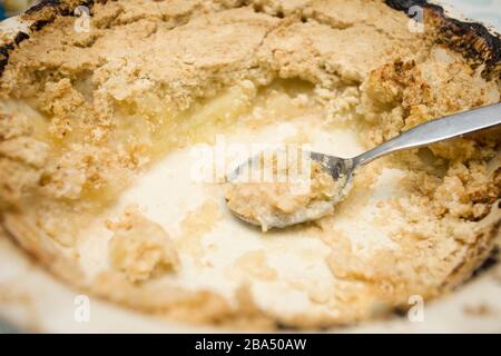 Close up of half eaten baked apple crumble Stock Photo
