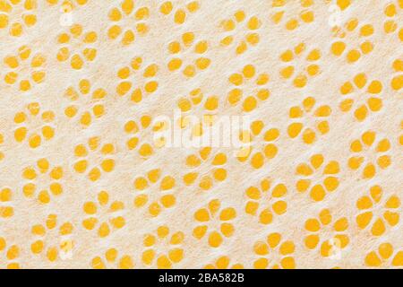 Background close up of yellow and white Japanese origami paper with flowers Stock Photo