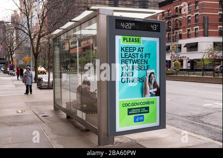 NEW YORK, NY - MARCH 25, 2020. Public Service message regarding the Coronavirus outbreak is displayed on a bus shelter on the Upper West Side of Manhattan in New York City. The World Health Organization declared coronavirus (COVID-19) a global pandemic on March 11th. Stock Photo