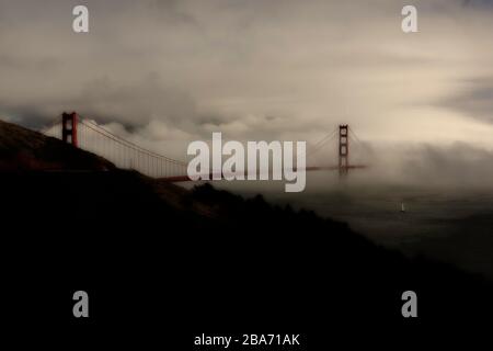 Golden view of Golden Gate Bridge in sun and fog from Marin Headlands, San Francisco, California, United States, North America, color Stock Photo