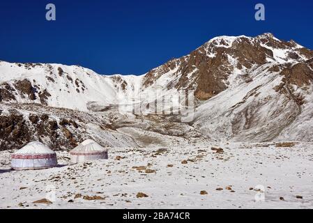 View of the yurts and the Ala Kul pass. The Ala Kul lake trail at the Terskey Alatau mountain range in the Tian Shan mountains. Kyrgyzstan, Central As