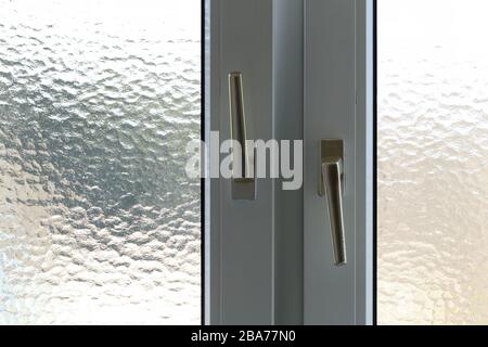 Window in the bathroom with hinged doors Stock Photo