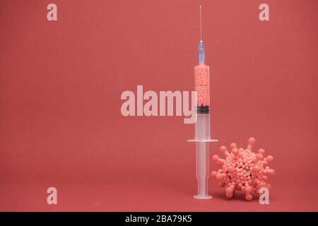 Beautiful syringe medical on a red background. Coronavirus concept, Protect yourself. Stock Photo