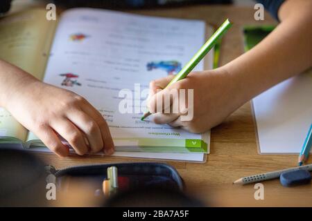 Joel solves his homework at home, learning in the corona crisis, on March 25th, 2020 at Ahlen/Germany. | usage worldwide Stock Photo
