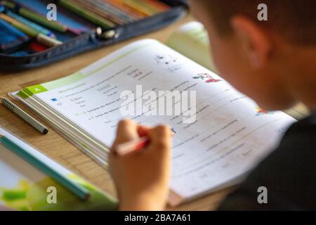 Joel solves his homework at home, learning in the corona crisis, on March 25th, 2020 at Ahlen/Germany. | usage worldwide Stock Photo