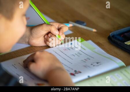 Joel solves his homework at home, learning in the corona crisis, on March 25th, 2020 at Ahlen / Germany. | usage worldwide Stock Photo