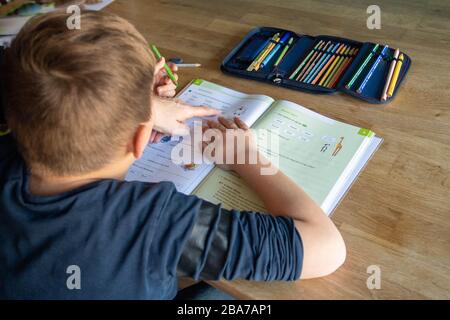 Joel solves his homework at home, learning in the corona crisis, on March 25th, 2020 at Ahlen / Germany. | usage worldwide Stock Photo