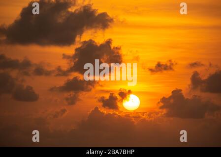 The golden light of the morning sun and clouds in the sky. Stock Photo