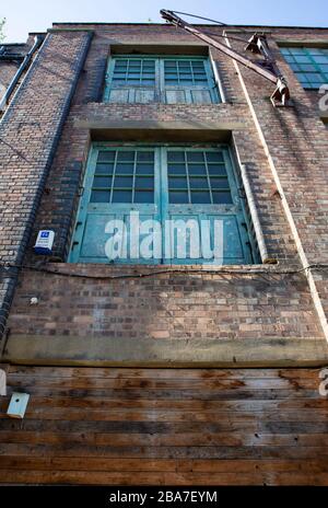 Building facade with winch and delivery doors Stock Photo