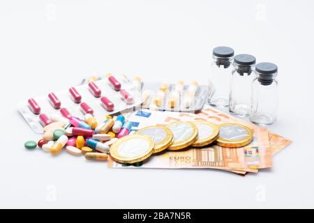 medicinale pills, cash and empty medicinale bottles isolated in front of a white background Stock Photo