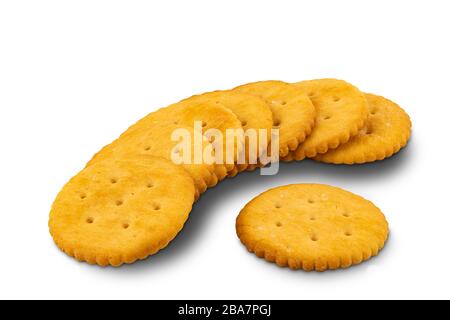Crunchy round crackers lay on the floor on white background with clipping path. Stock Photo