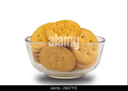 Pile of round crackers in glass bowl on white background with clipping path Stock Photo