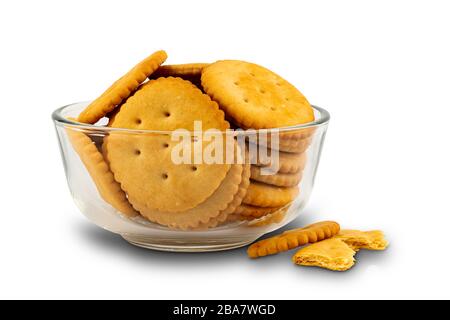 Pile of freshly baked crunchy crackers in a glass bowl on white background with clipping path. Stock Photo