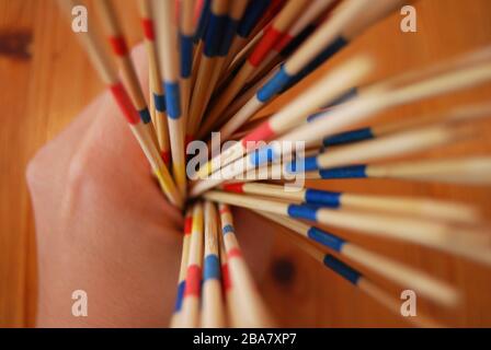 Wooden stick game in hands, playing toys - hobbies kids or adults Stock Photo