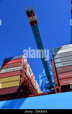 Rotterdam, The Netherlands - August 2019; low angle view and image filling section of container handling; ship to shore in the terminal with gantry cr