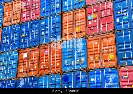 image filling view of fronts of many colorful containers stacked high up Stock Photo