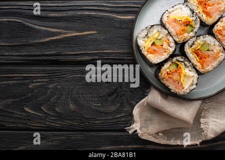 top view of plate with korean gimbap on wooden surface Stock Photo