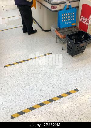Markings on the floor to implement social distancing measures at the checkout of a Sainsbury's store in Peterborough, after Prime Minister Boris Johnson has put the UK in lockdown to help curb the spread of the coronavirus.