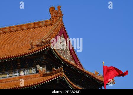 Beijing, China - October 2019; Low angle close up view of one of the iconic red roofs of the Forbidden city in Beijing against a blue sky with the typ Stock Photo