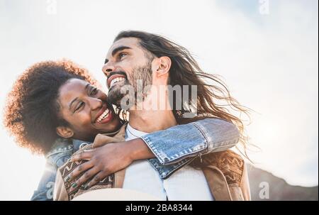 Multiracial couple having tender moments outdoor - Caucasian man and african woman having fun together during vacation - Travel, love and multi thnic Stock Photo