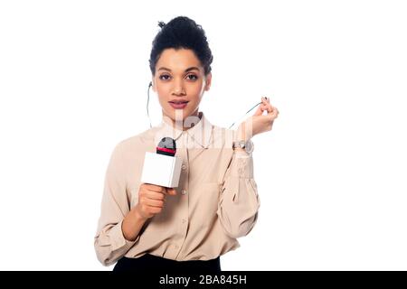 Front view of african american journalist with microphone and headphones looking at camera isolated on white Stock Photo