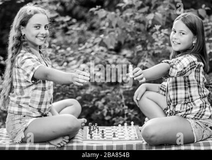 dont be a pawn. wunderkind. make the brain work. early childhood development. worthy opponents. develop hidden abilities. two concentrated girls play chess. chess playing sisters. child prodigies. Stock Photo