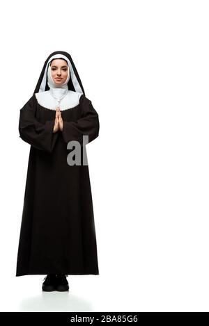 beautiful young praying nun standing on white Stock Photo