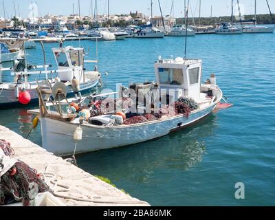 Portocolom Mallorca Spain 31 May 2019 typical fishing boat trawler in the harbour with nets and equipment ready to set sail Stock Photo