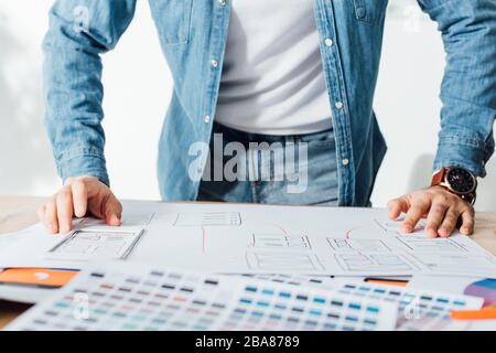 Cropped view of ux designer using app sketches and color palettes on table in office Stock Photo