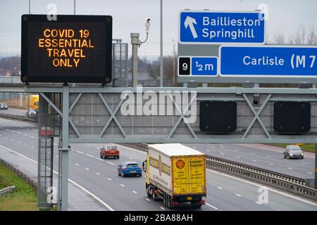 Glasgow, Scotland, UK. 26 March, 2020.Variable message sign on M8 Motorway in Glasgow instructing drivers that only essential travel is permitted during the Covid-19 lockdown in the UK. Iain Masterton/Alamy Live News Stock Photo