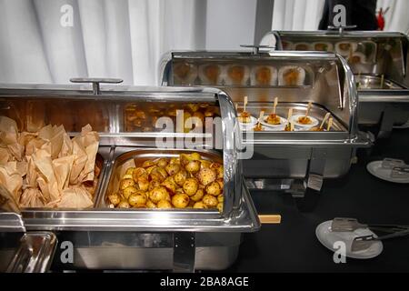 Catering buffet food with heated trays ready for service  in a hotel Stock Photo