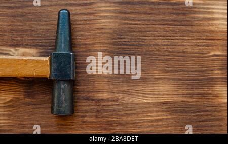 Old repair tool hammer on brown color wooden background. Labor day concept Stock Photo