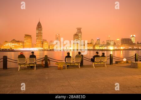 Shanghai, China - People watching The Bund skyline across the Huangpu river from Pudong. Stock Photo