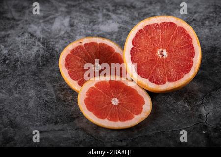 Sliced juicy fresh grapefruit on a marble Stock Photo