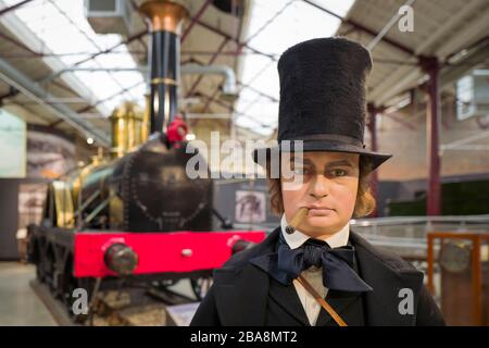 A life-size model of Isambard Kingdom Brunel, famous Victorian entrepreneur and engineer in front of a replica of one of his first steam locomotives o Stock Photo