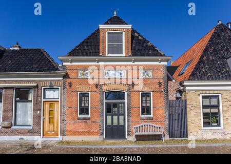 Historic red brick house in the Frisian village Makkum, Netherlands Stock Photo