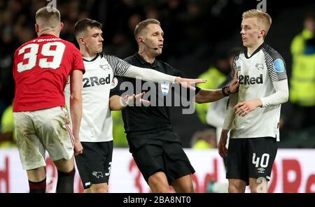 Derby County's Louie Sibley (right) reacts after a challenge by Manchester United's Scott McTominay (left) Stock Photo