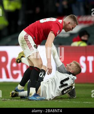 Derby County's Louie Sibley (right) reacts after a challenge by Manchester United's Scott McTominay Stock Photo