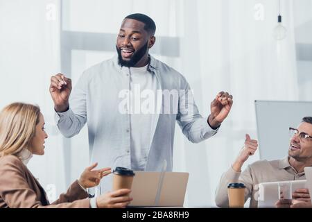 african american man talking with colleagues during meeting in creative agency Stock Photo