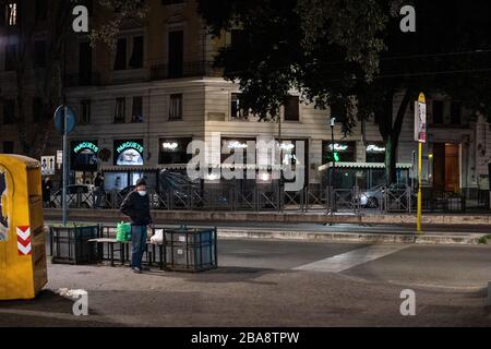 In Rome, during the terrible Coronavirus epidemic that hit Italy, the volunteers of the Community of Sant'Egidio distribute meals and health services to homeless people and other disadvantaged people who live on the streets. Stock Photo