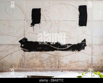 Old tiles and textures on decaying house wall Stock Photo