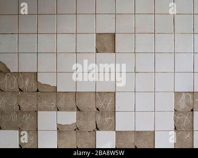 Old tiles and textures on decaying house wall Stock Photo