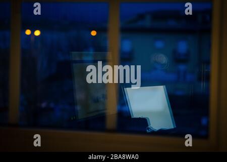 Reflection of a computer out the window at night, working from home at night Stock Photo